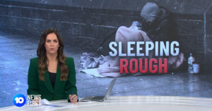 A newsreader with the words sleeping rough on the screen behind her