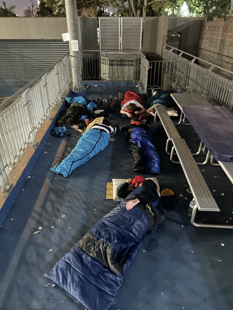 Reidy House students getting involved in Rough Night In October 2024 by sleeping in sleeping bags outside at St Joseph's College, Gregory Terrace