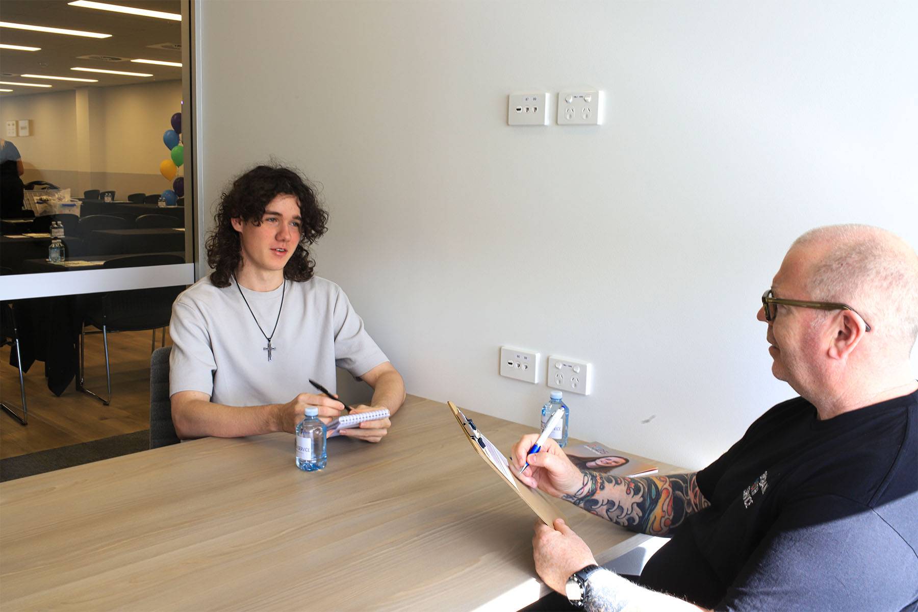 Young person talks to Brisbane Youth Service Housing Senior Manager Jason McDonald