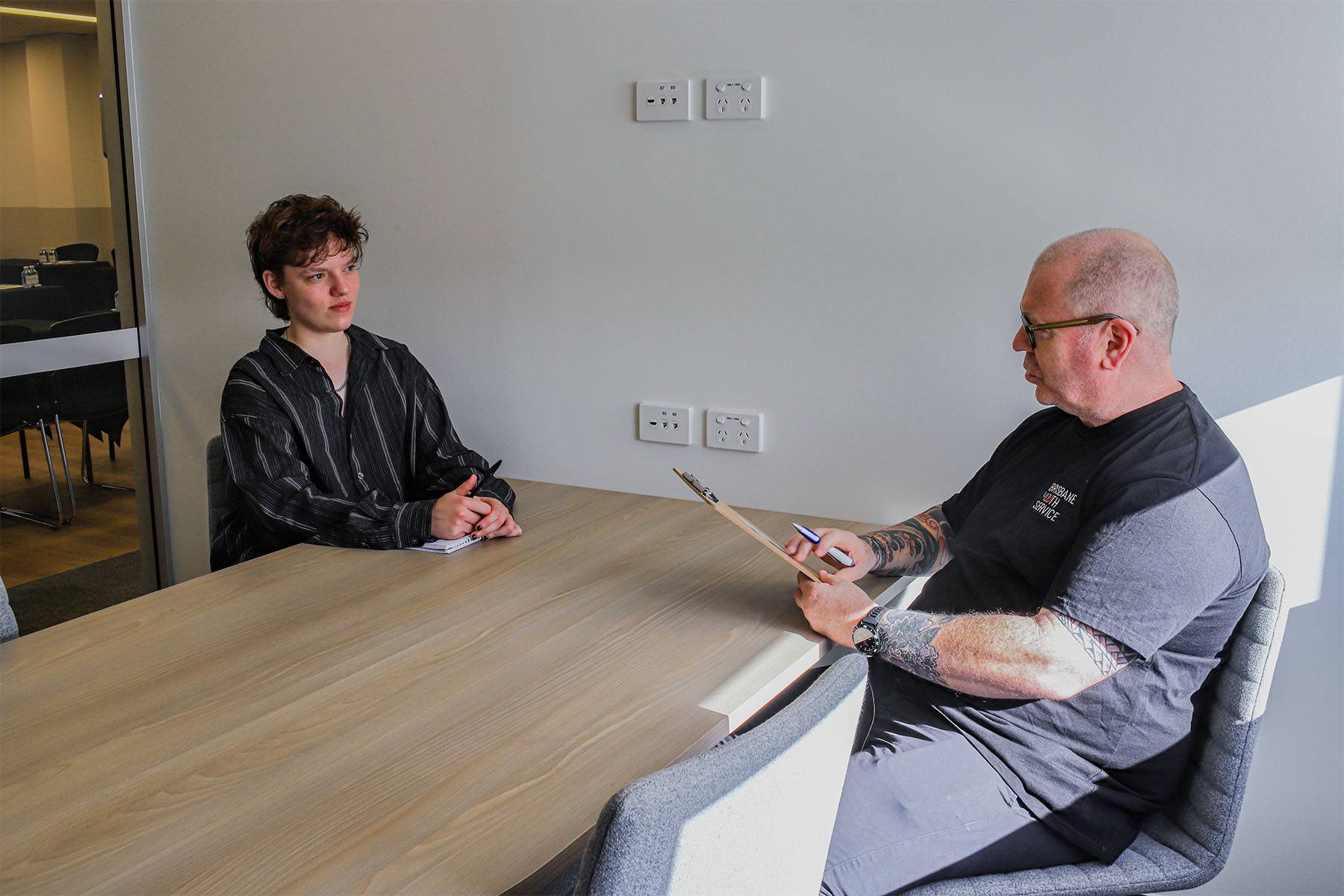Young person talks to Brisbane Youth Service Housing Senior Manager Jason McDonald